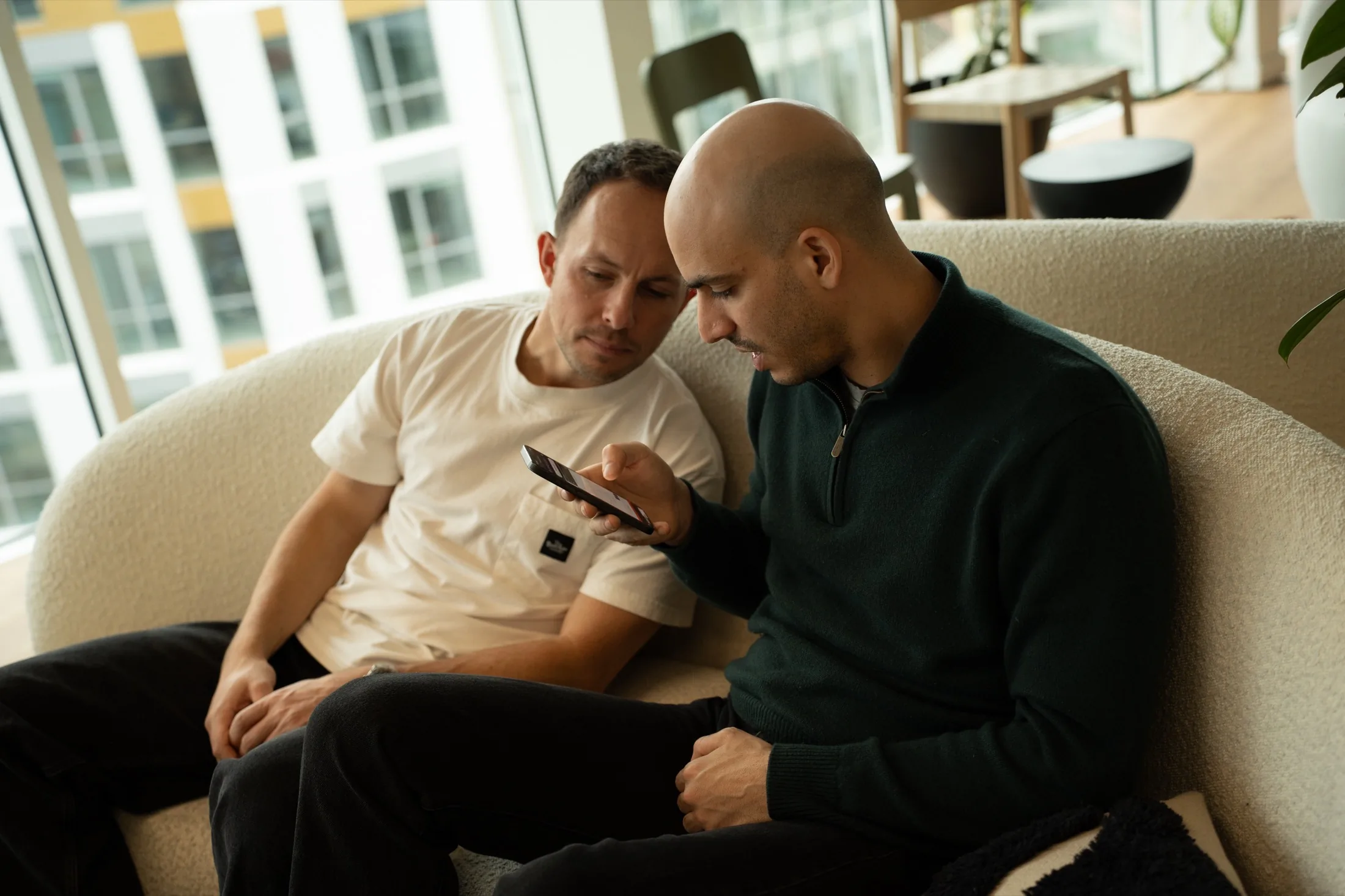 Two of the Rebind team looking at the app